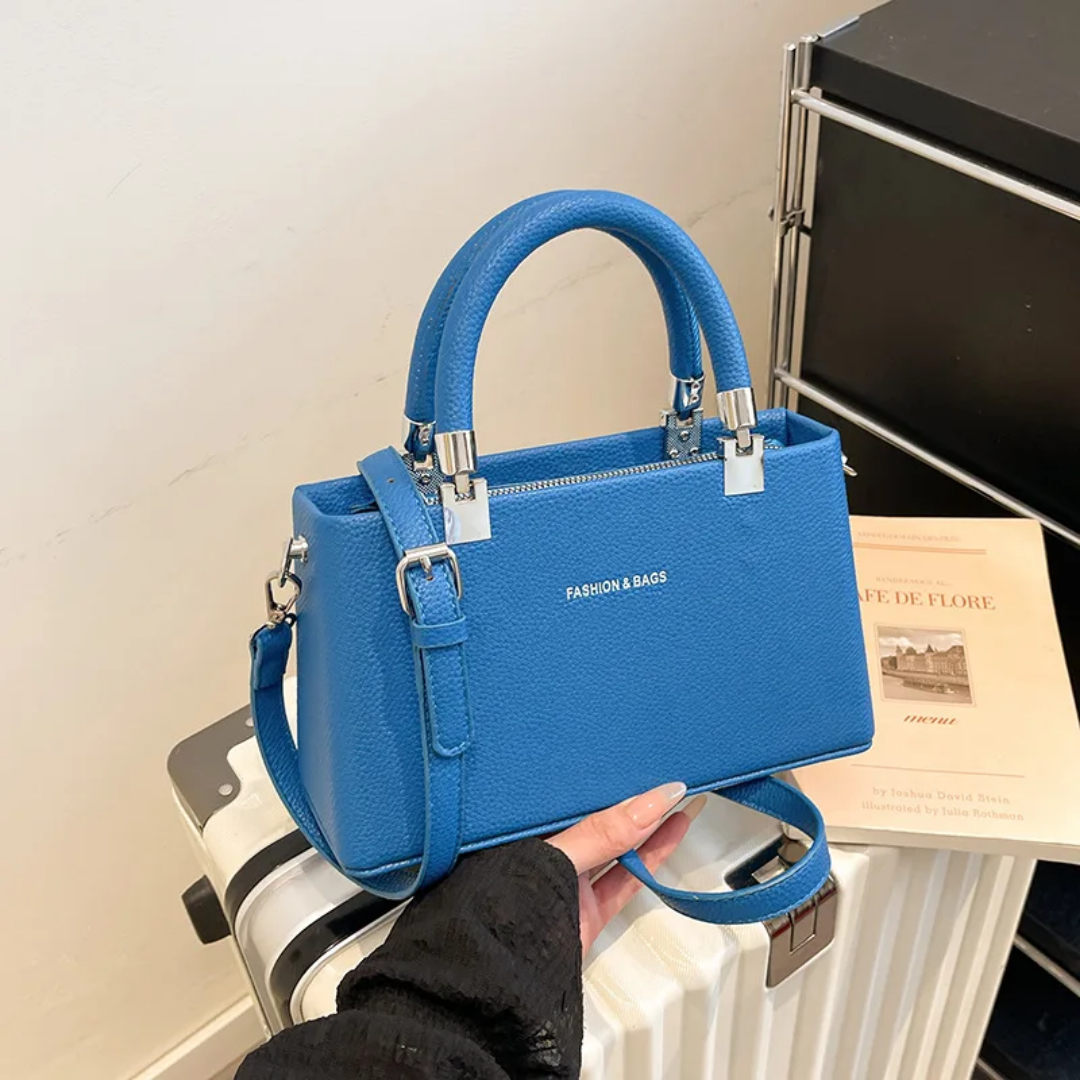 Small faux leather top-handle bags with a crossbody strap option. 