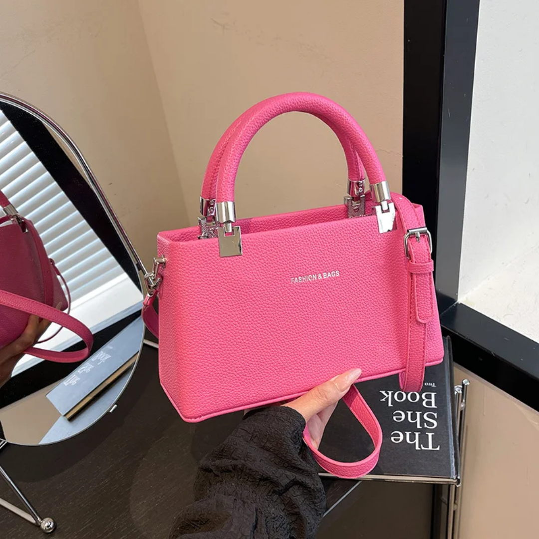 Small faux leather top-handle bags with a crossbody strap option. 