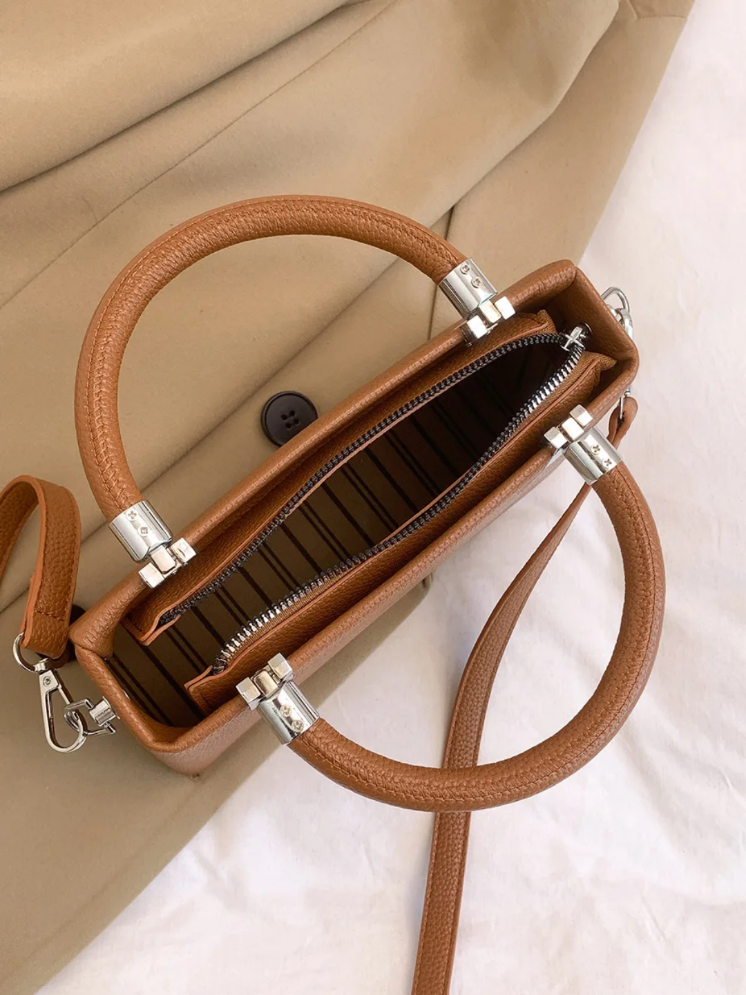 Small faux leather top-handle bags with a crossbody strap option. 