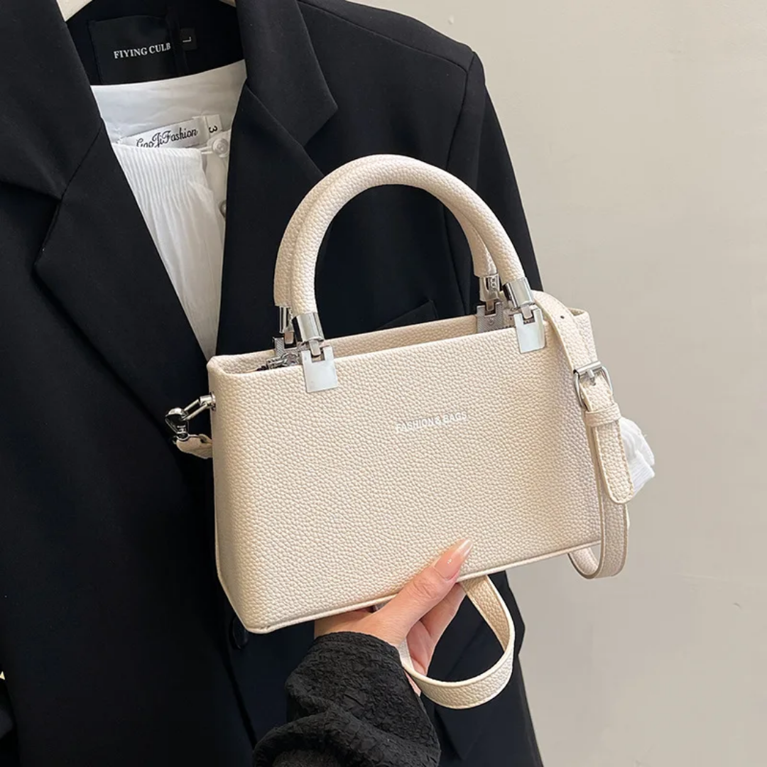 Small faux leather top-handle bags with a crossbody strap option. 